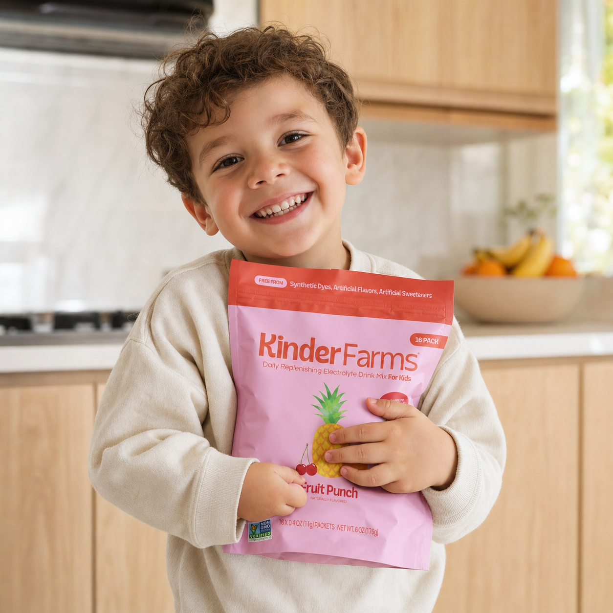 Happy kid hugging a KinderFarms Fruit Punch pouch in the kitchen