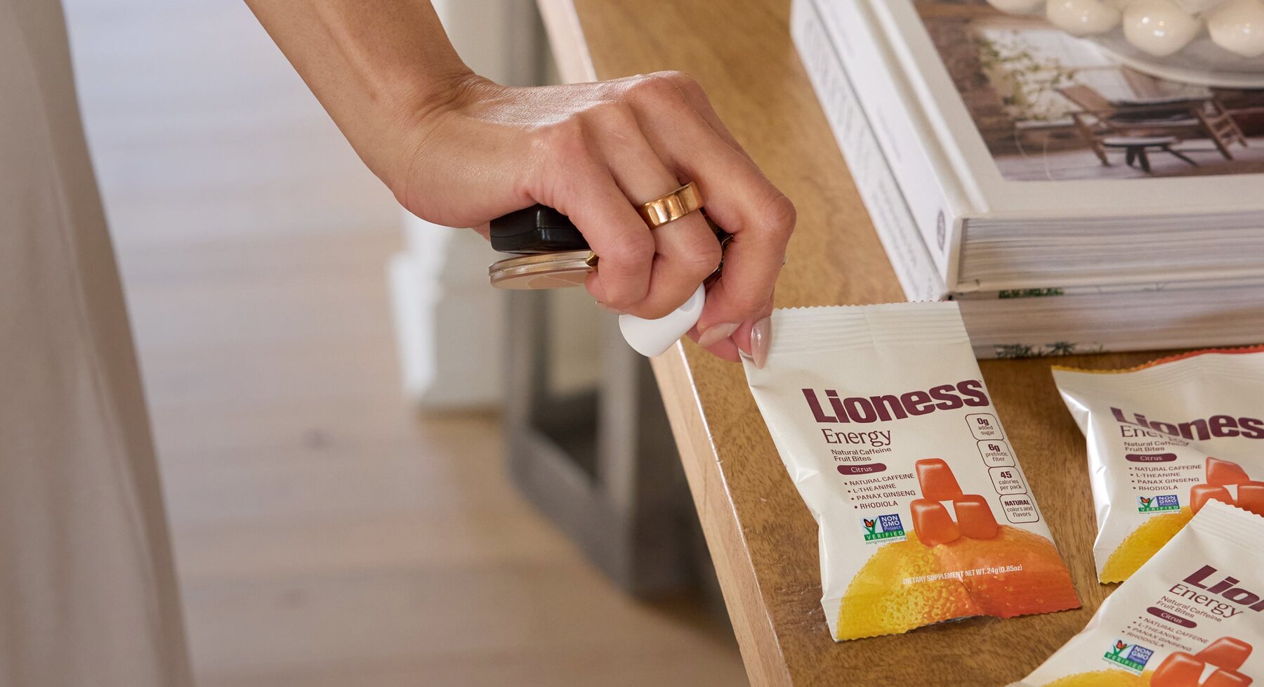 A hand reaching into a drawer of Lioness packs
